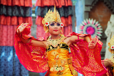 Denpasar, Bali island, Indonesia - July 11, 2015: Portrait of beautiful young Balinese woman in ethnic dancer costume, dancing traditional temple dance at art and culture festival parade.のeditorial素材