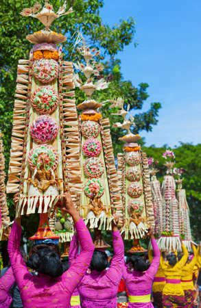 Group of beautiful Balinese women in costumes - sarong, carry offering for Hindu ceremony. Traditional dances, arts festivals, culture of Bali island and Indonesia people. Indonesian travel backgroundの写真素材