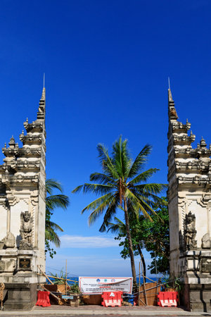 Kuta, Bali Island, Indonesia - April 16, 2020: Banner with warning sign on entrance gate to beach closed to prevent spread of coronavirus outbreak. Travel industry crisis due virus COVID-19 pandemic.のeditorial素材