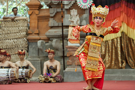 Denpasar, Bali island, Indonesia - June 23, 2016: Portrait of beautiful young Balinese woman in ethnic dancer costume, dancing traditional temple dance at art and culture festival parade.のeditorial素材