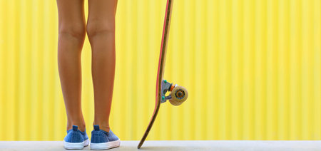 Young skateboarder girl in skate park. Close up view of legs, sneakers, skateboard. Active family...