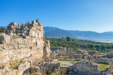 Mother with kids looking at acropolis of Xanthos ancient city - part of Lycian way. Largest city of Lycia. Popular travel destination in Antalya Turkeyの写真素材