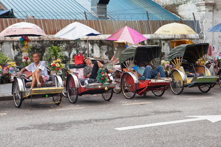 Penang, Malaysia - September 02, 2014: Vintage Trishaw stop beside road for service traveller in George town, Penang, Malaysia.のeditorial素材