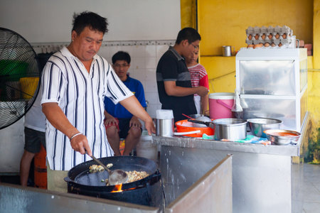 Georgetown, Penang, Malaysia - September 01, 2014: Daily work at fast food cafe at street in historical Georgetown, Penang, Malaysiaのeditorial素材