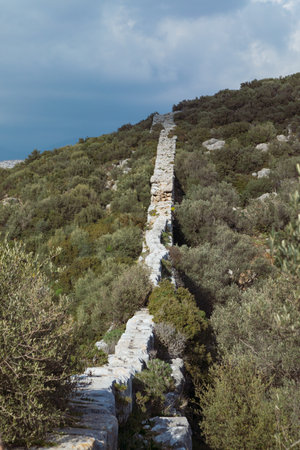 Ruins of old Roman Aqueduct. View Delikkemer Bridge at olive forest near Mediterranean sea coast. Near to Patara Ancient City at location Kalkan, Kas, Antalya. Popular travel destination in Turkeyの写真素材