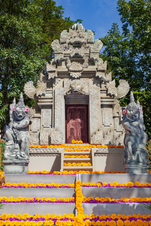 Traditional Balinese temple with guard spirits. Decorated by flowers for religious holidays.の写真素材