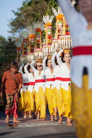 Denpasar, Bali island, Indonesia - June 11, 2016: Procession of beautiful Balinese women in...