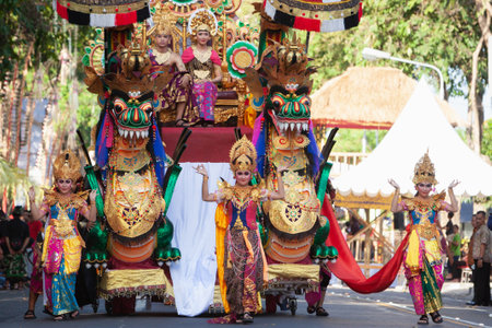 Denpasar, Bali island, Indonesia - June 11, 2016: Beautiful indonesian people in colorful sarongs with religious offers - traditional Balinese style ethnic dancer costumes at street paradeのeditorial素材