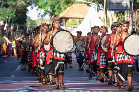 Denpasar, Bali island, Indonesia - June 11, 2016: Young men dressed in ethnic Balinese people...