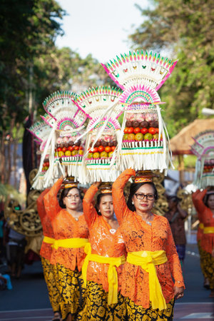 Denpasar, Bali island, Indonesia - June 11, 2016: Procession of beautiful Balinese women in...