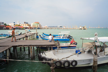 Georgetown, Penang, Malaysia - September 03, 2014: Pier on stilts with boats in Chew Jetty sea...
