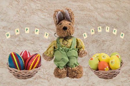 Easter bunny and Easter eggs in a basket with a happy wishes .