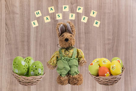 Easter bunny and Easter eggs in a basket with a happy wishes .