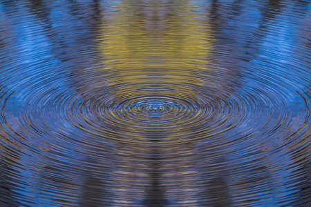 Ripples autumn scene on water.の写真素材