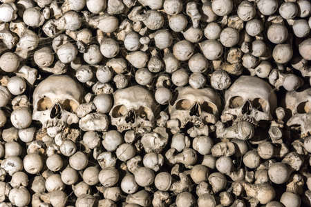 A large number of human skulls and bones in the web, folded as decorations of the Churchの写真素材