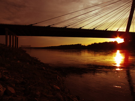 Sunset behind a beautiful bridge and riverの写真素材