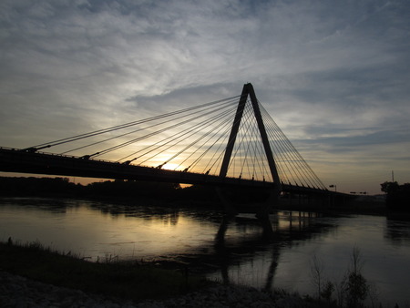 Sunset behind a beautiful bridge and riverの写真素材