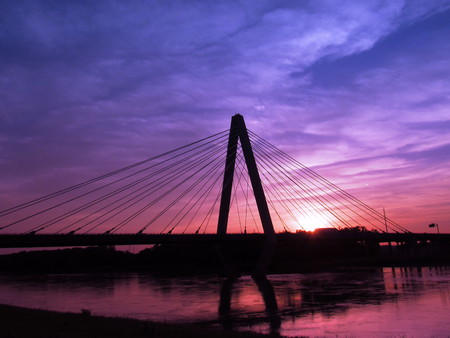 Sunset behind a beautiful bridge and riverの写真素材