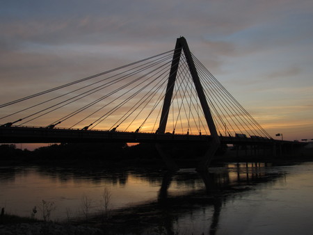 Sunset behind a beautiful bridge and riverの写真素材