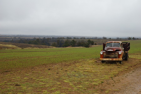 Rusty car in a fieldの写真素材