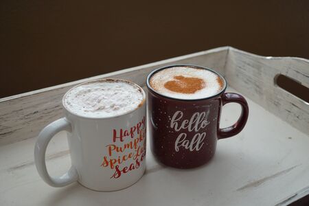 Hot beverages on a wooden trayの写真素材
