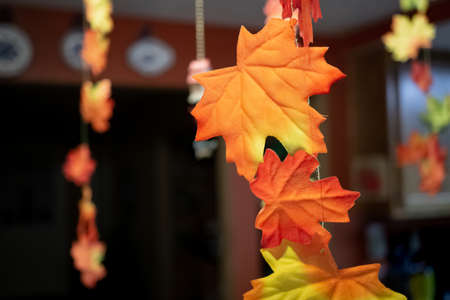 Orange leaves decorating a kitchen tableの写真素材