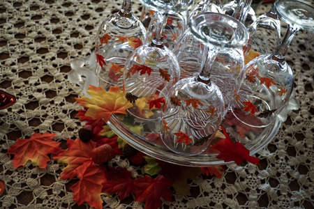 Wine glass decoration with fall colored leavesの写真素材