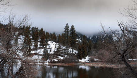 Foggy Autumn mountains with a nearby lakeの写真素材