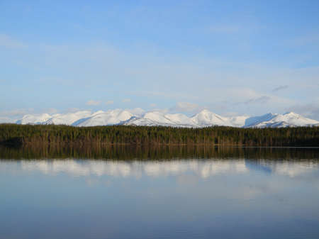 Snowy mountains reflected in lakeの写真素材