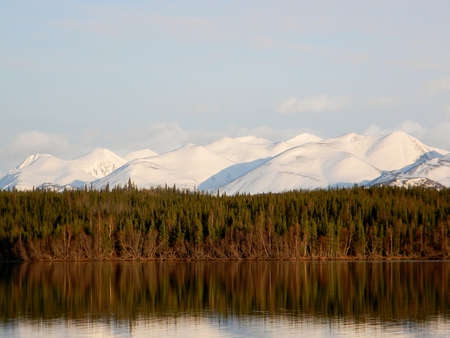 Alaskan snow covered mountains reflected in lake waterの写真素材
