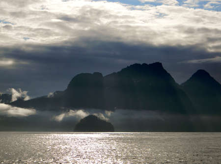 Sunrays over the mountains and oceanの写真素材