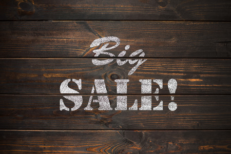 word Sale written on a old vintage wooden plateの写真素材