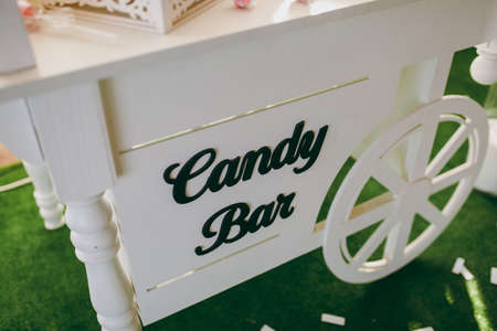 Details of a tasty candy bar with jugs of sweets, cookies and marshmallowsの写真素材