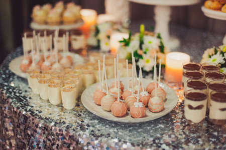 Details of a tasty candy bar with jugs of sweets, cookies and marshmallows