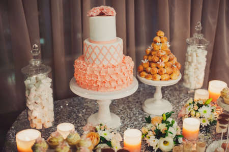 Details of a tasty candy bar with jugs of sweets, cookies and marshmallows