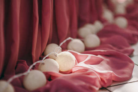 Wedding. Banquet. The chairs and table for guests, decorated with candles, served with cutlery and crockery and covered with a tablecloth. The table stands on a green lawn in the backyard banquet areaの写真素材