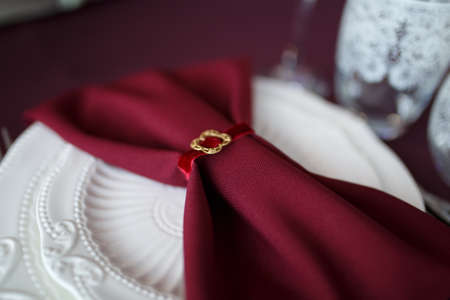 Wedding. Banquet. The chairs and table for guests, decorated with candles, served with cutlery and crockery and covered with a tablecloth. The table stands on a green lawn in the backyard banquet areaの写真素材