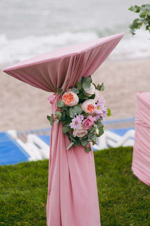 Original wedding floral decoration in the form of mini-vases and bouquets of flowers hanging from the ceilingの写真素材