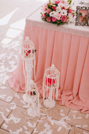 Original wedding floral decoration in the form of mini-vases and bouquets of flowers hanging from the ceilingの写真素材