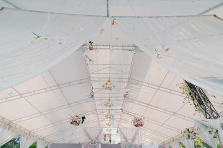 Original wedding floral decoration in the form of mini-vases and bouquets of flowers hanging from the ceilingの写真素材