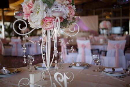 Original wedding floral decoration in the form of mini-vases and bouquets of flowers hanging from the ceilingの写真素材