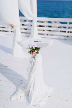 Original wedding floral decoration in the form of mini-vases and bouquets of flowers hanging from the ceilingの写真素材