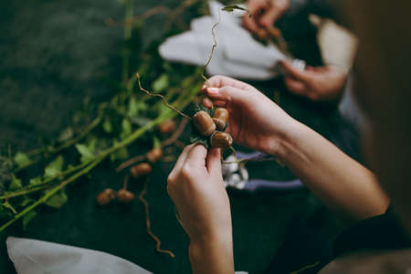 Original wedding floral decoration in the form of mini-vases and bouquets of flowers hanging from the ceilingの写真素材