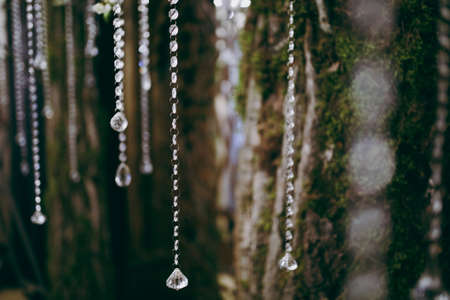 Original wedding floral decoration in the form of mini-vases and bouquets of flowers hanging from the ceilingの写真素材