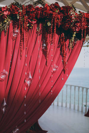 Original wedding floral decoration in the form of mini-vases and bouquets of flowers hanging from the ceilingの写真素材