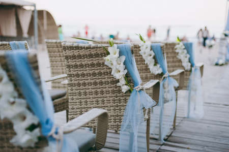 Decoration of chairs at the wedding. Beautiful chairs with decorations