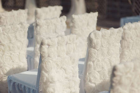 Decoration of chairs at the wedding. Beautiful chairs with decorationsの写真素材