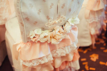 Decoration of chairs at the wedding. Beautiful chairs with decorationsの写真素材