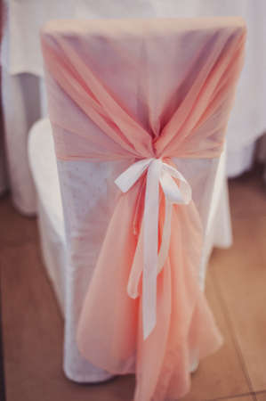 Decoration of chairs at the wedding. Beautiful chairs with decorationsの写真素材