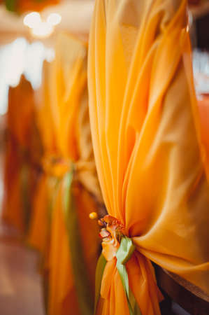 Decoration of chairs at the wedding. Beautiful chairs with decorationsの写真素材